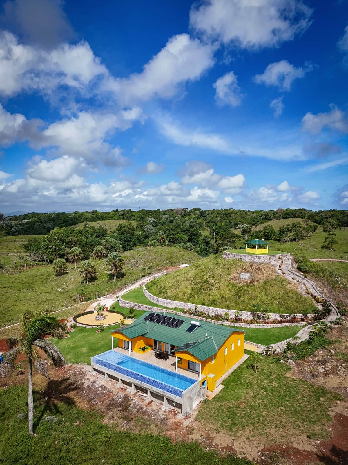 The Yellow House with its pool and tropical hillside surroundings