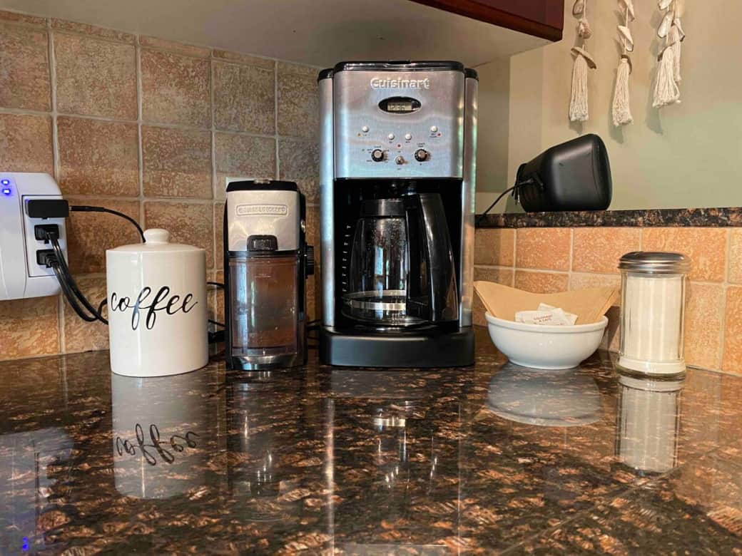 Coffee bar with fresh coffee beans and grinder.