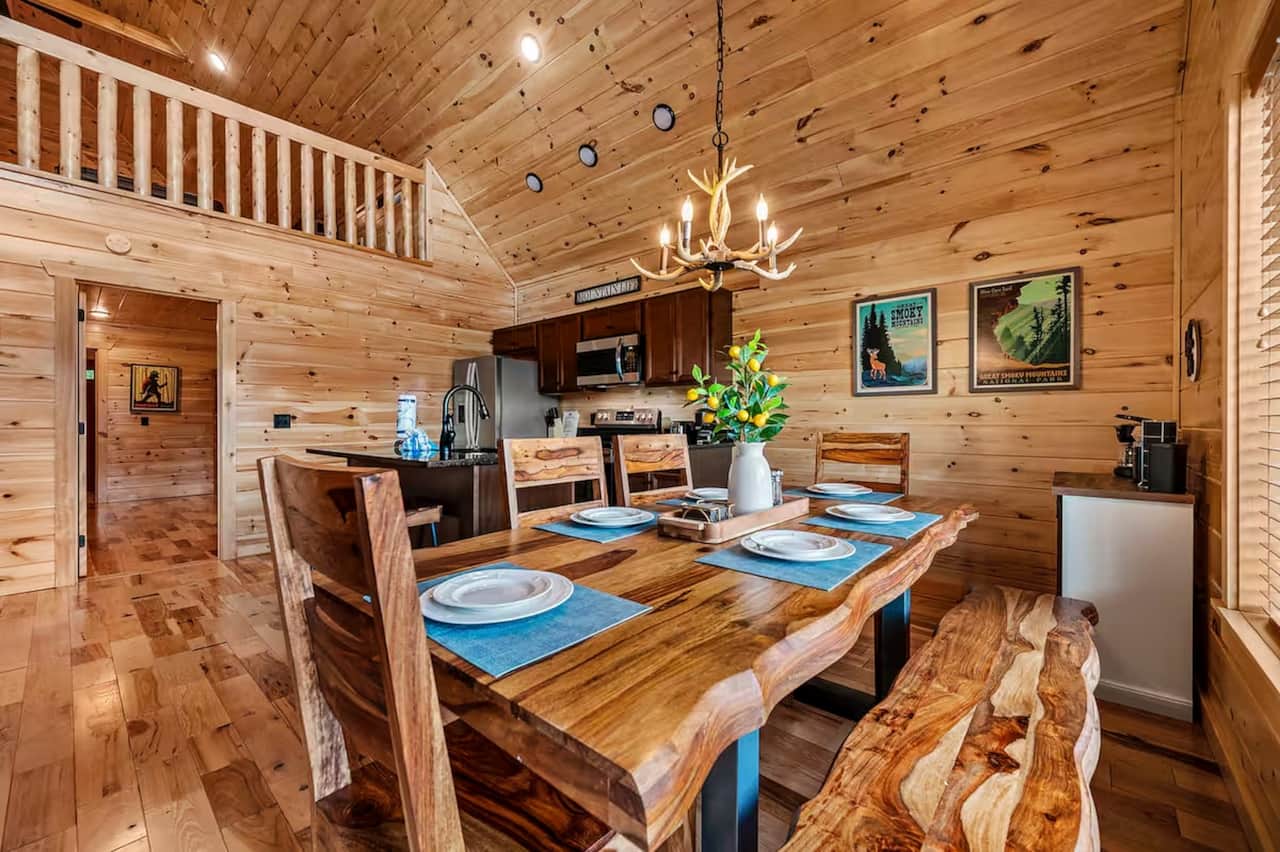 Generous dining area with a handcrafted live-edge table, bench seating, and room for the whole group
