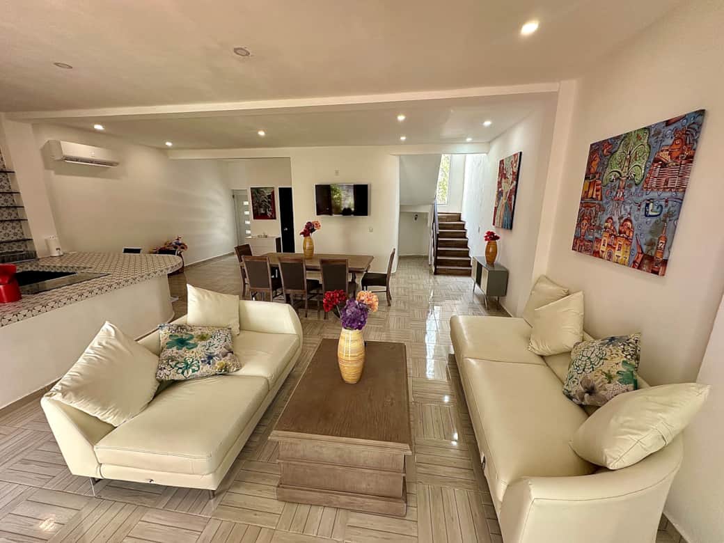 Open living space: living room, kitchen, dining area, patio with grill