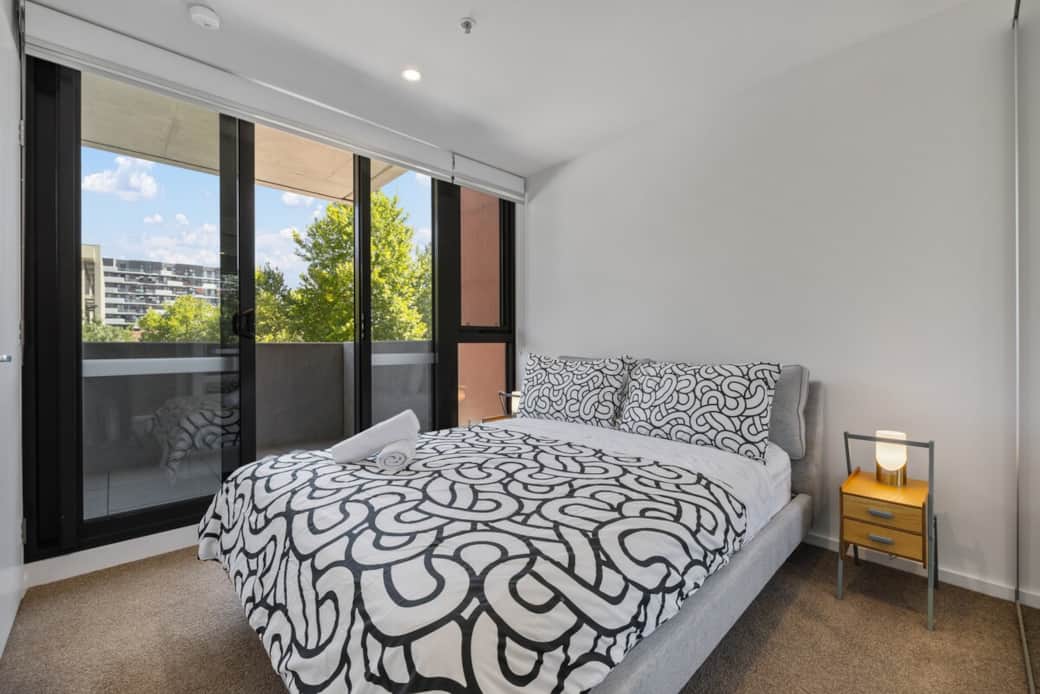 Relax in this stylish bedroom, featuring a comfortable bed, cozy lighting, and direct balcony access. The perfect place for a restful night’s sleep after exploring the city.