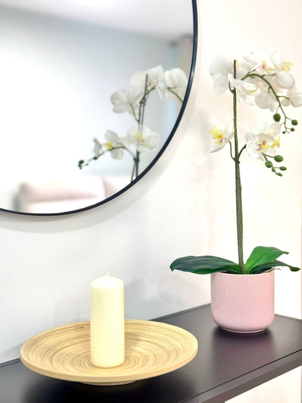 Decorative mirror with floral accents enhancing light and space.