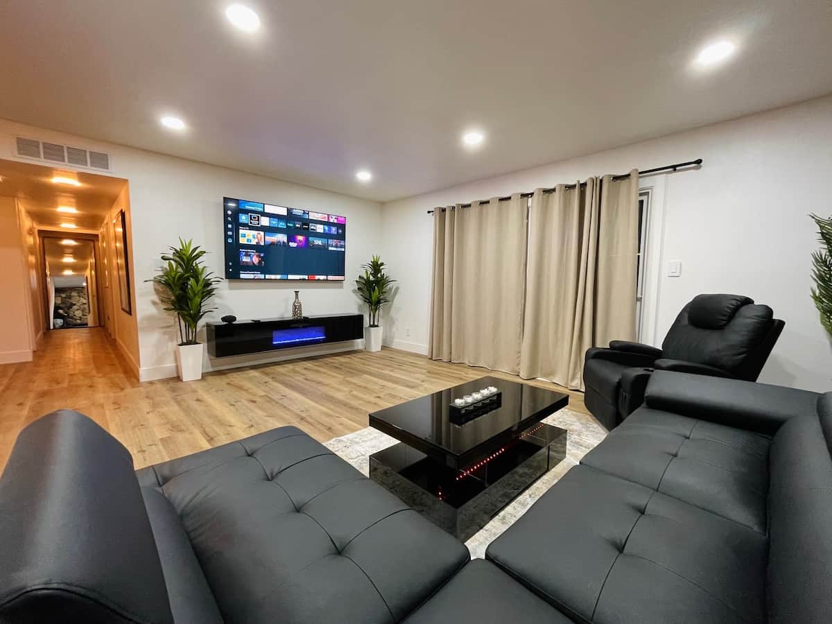 Large Spacious Living room with Sectional, heated recliner and 75 in Smart Tv. Modern Fireplace