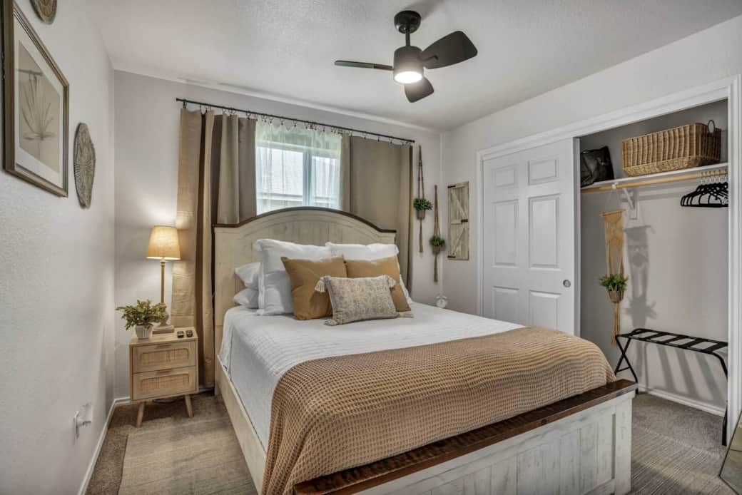Comfortable and well lit guest bedroom with a ceiling fan, bedside tables and lamps, alarm clock, clothes hamper, oscillating fan, luggage rack, clothes hangers, and extra linens. Comfortable and well lit guest bedroom with a ceiling fan, bedside tables and lamps, alarm clock, clothes hamper, oscillating fan, luggage rack, clothes hangers, and extra linens.