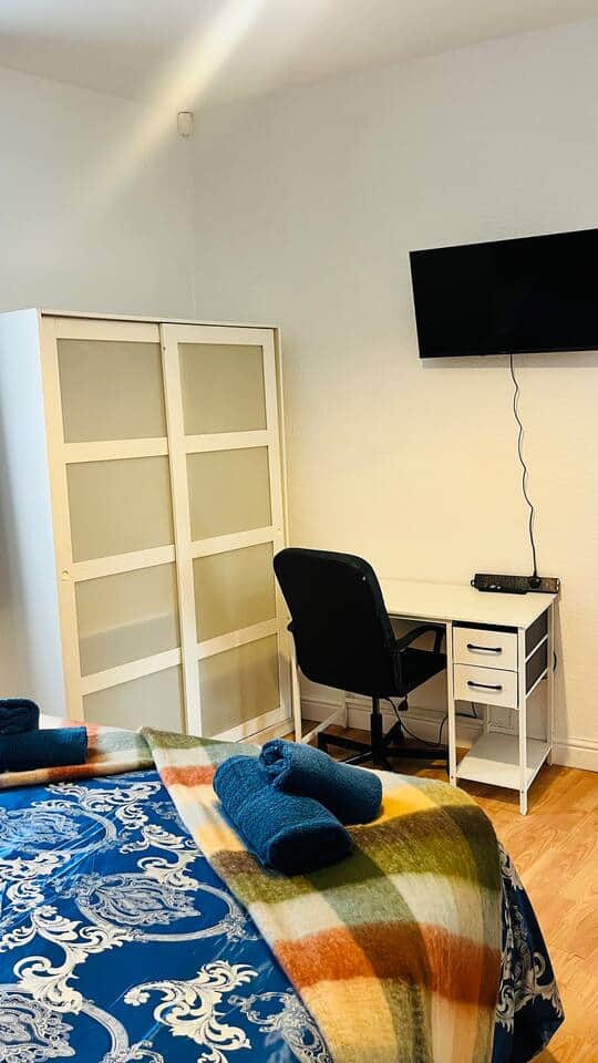 Two door wardrobe with hangers has ample storage space, also there is an over door hanging hook for coats Two door wardrobe with hangers has ample storage space, also there is an over door hanging hook for coats