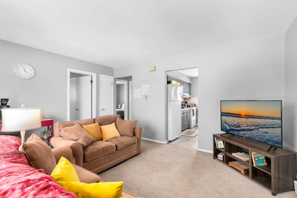 Comfortable Living Room! Lots of Natural light, a coffee bar, and 4K Smart TV