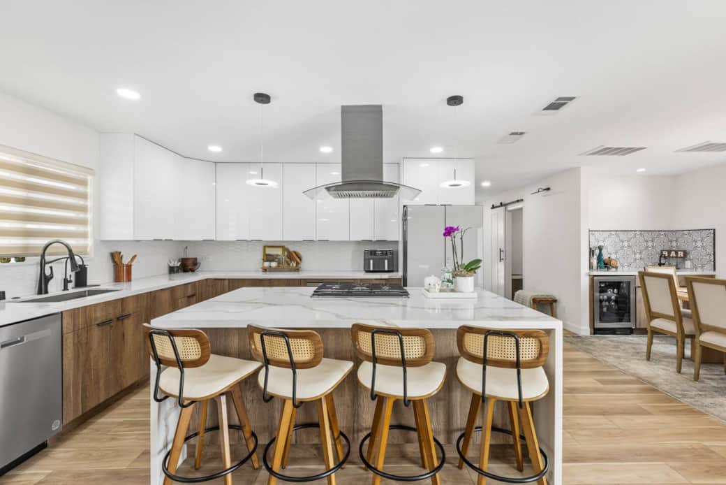 Gather around the marble island with comfy bar stools, perfect for casual meals or conversation.