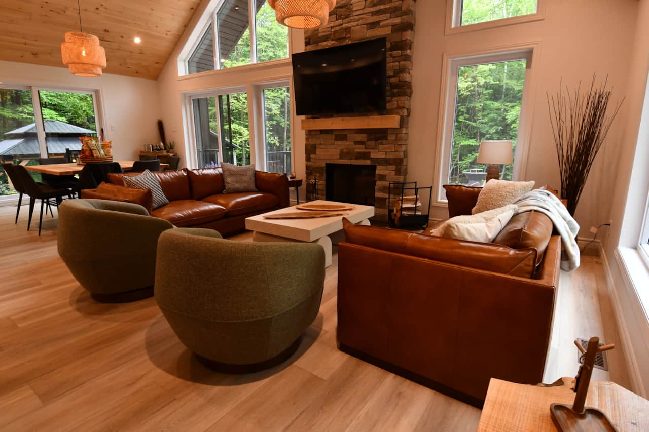 A warm and inviting space designed for gatherings, featuring large windows.