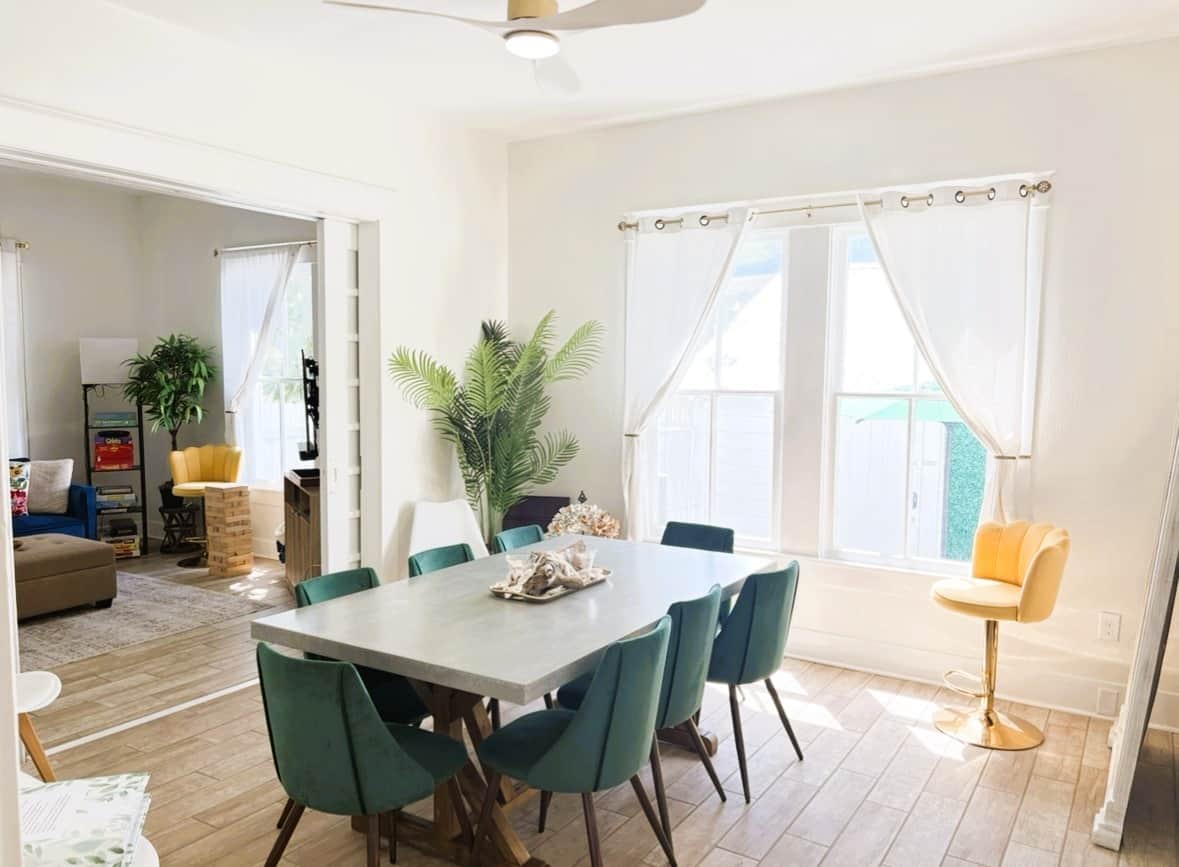Large stone dining table seating up to 10 inside White Magnolia Galveston vacation home
