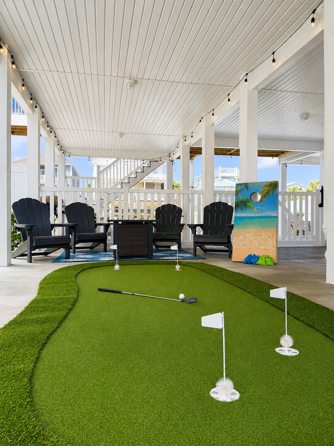 Private putting green and outdoor game area at Coastal Crown