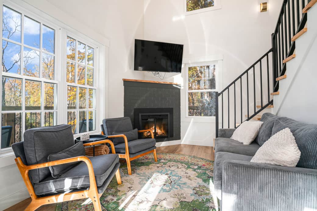 Enjoy cozy conversations by the fireplace, sat high amongst the trees Enjoy cozy conversations by the fireplace, sat high amongst the trees