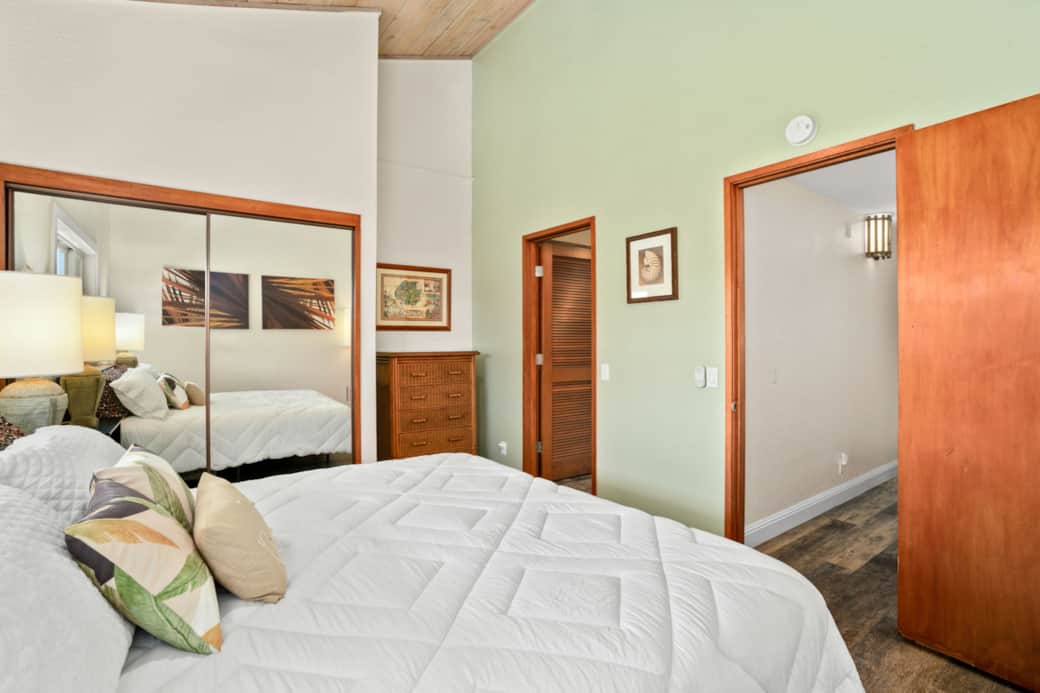 Bedroom with mirrored closet, warm wood accents, and a clean, inviting layout