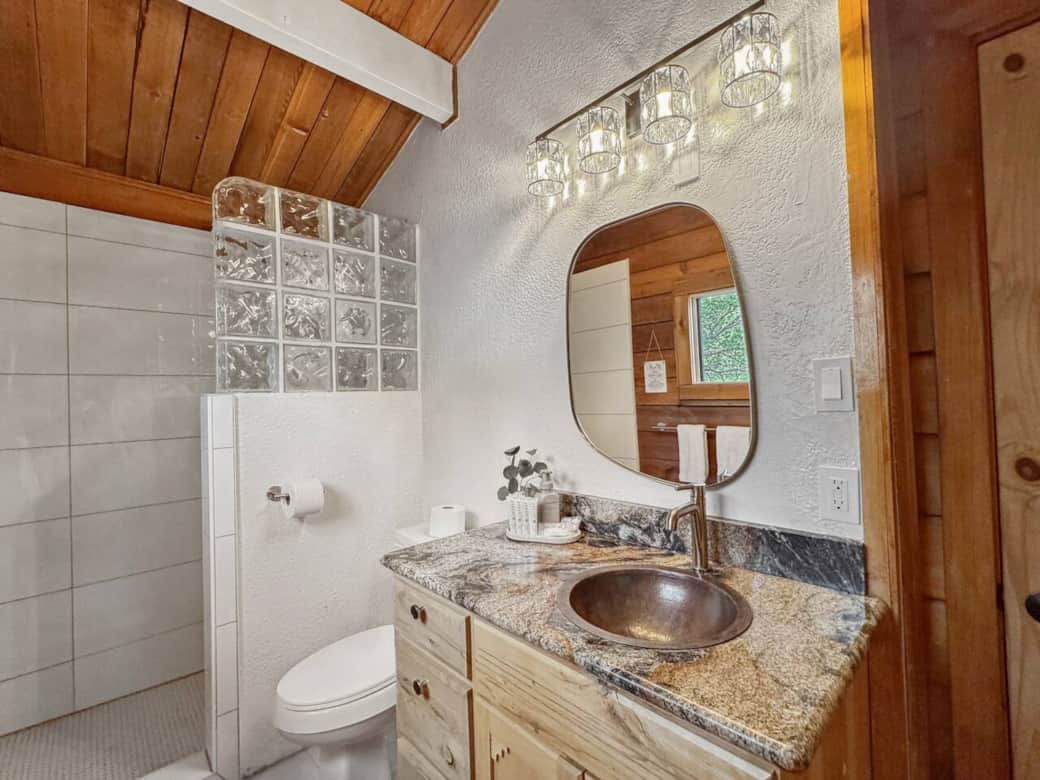 Recently remodeled, this elegant second-floor bathroom features new tile and a luxurious rainforest shower, creating a spa-like retreat. Stocked with high-quality essentials, you’ll find everything you need for a refreshing and comfortable stay. Recently remodeled, this elegant second-floor bathroom features new tile and a luxurious rainforest shower, creating a spa-like retreat. Stocked with high-quality essentials, you’ll find everything you need for a refreshing and comfortable stay.