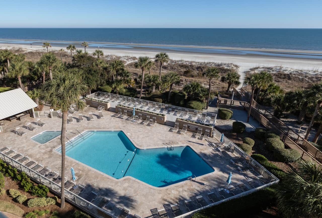View of pool and pool house on left