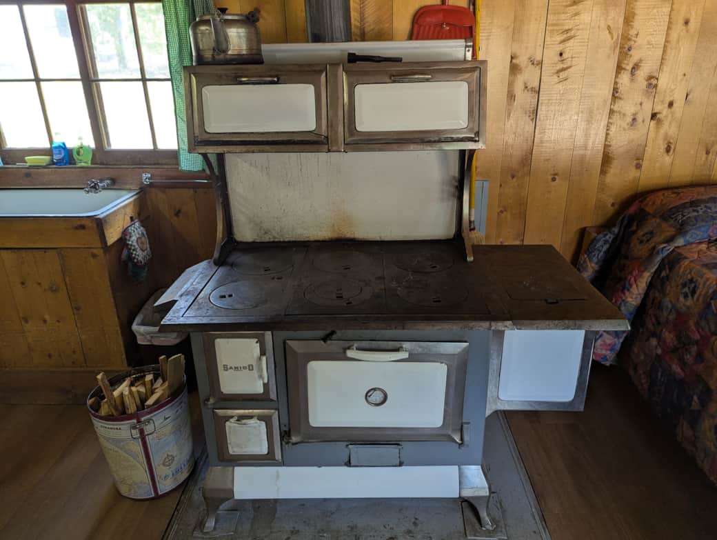 Cabin 3 is a cozy rustic cabin that features a wood-burning stove.