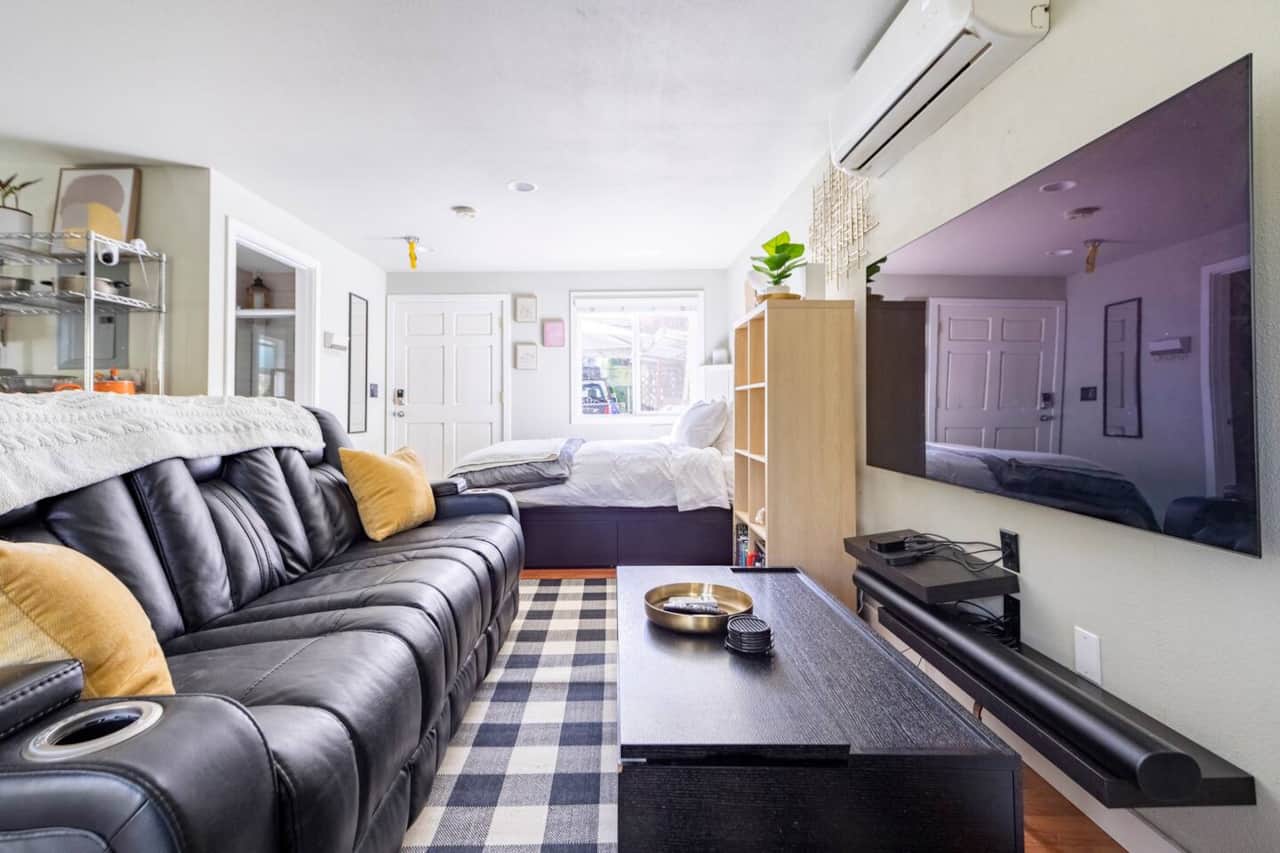 65" LG OLED TV, Sonos Arc with Dolby Atmos, and leather sectional for movie nights