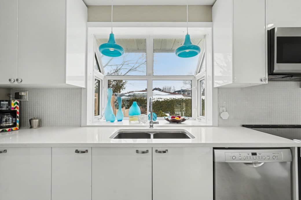 Bright, modern kitchen with sleek cabinetry, stainless steel appliances, and a view of the backyard.