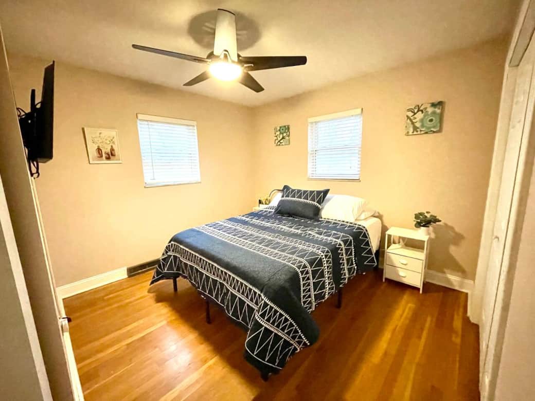 Queen bed with a Roku TV and night stands with charging ports