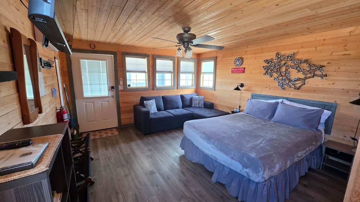 Comfortable cabin living space with a queen-sized bed and inviting seating area.