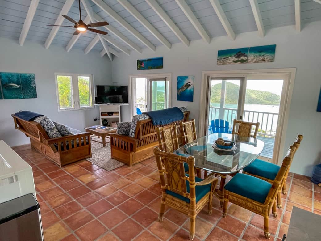 Water+Sky USVI | Main Floor Dining & Living Area with 3 Double Sliders Overlooking Coral Bay Harbor Water+Sky USVI | Main Floor Dining & Living Area with 3 Double Sliders Overlooking Coral Bay Harbor