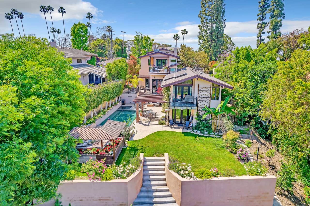 Soar above and witness the stunning aerial shot of this extraordinary house. Take in its grandeur, set against the backdrop of nature, revealing its true splendor from a unique vantage point.
