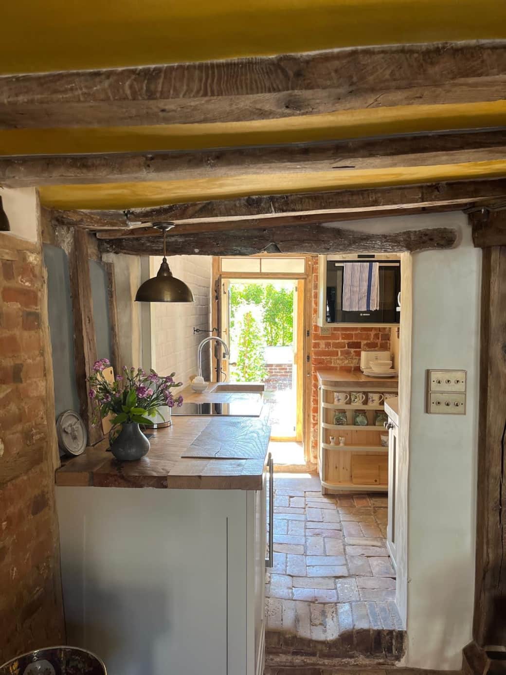 Handmade kitchen featuring reclaimed oak worktops, wine cooler, induction hob and dishwasher Handmade kitchen featuring reclaimed oak worktops, wine cooler, induction hob and dishwasher