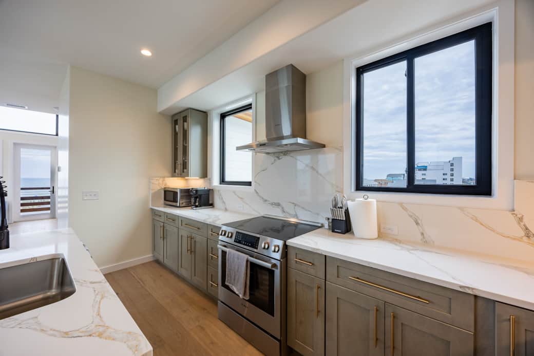 Modern kitchen with island at Driftwood Carolina luxury beach house