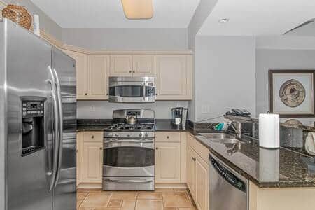 Fully stocked kitchen featuring granite countertops and stainless steel appliances