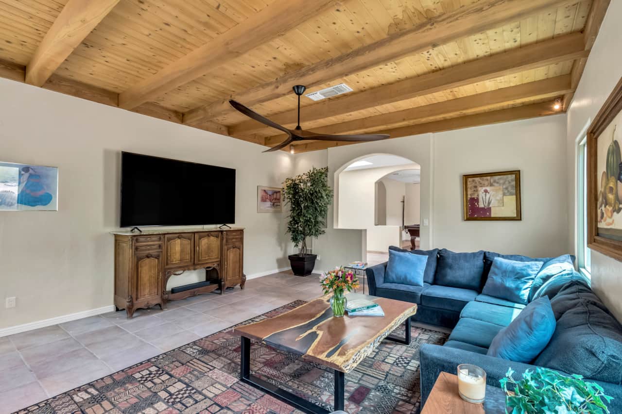 Living room with 86" tv and sonos sound and extensive movie collection