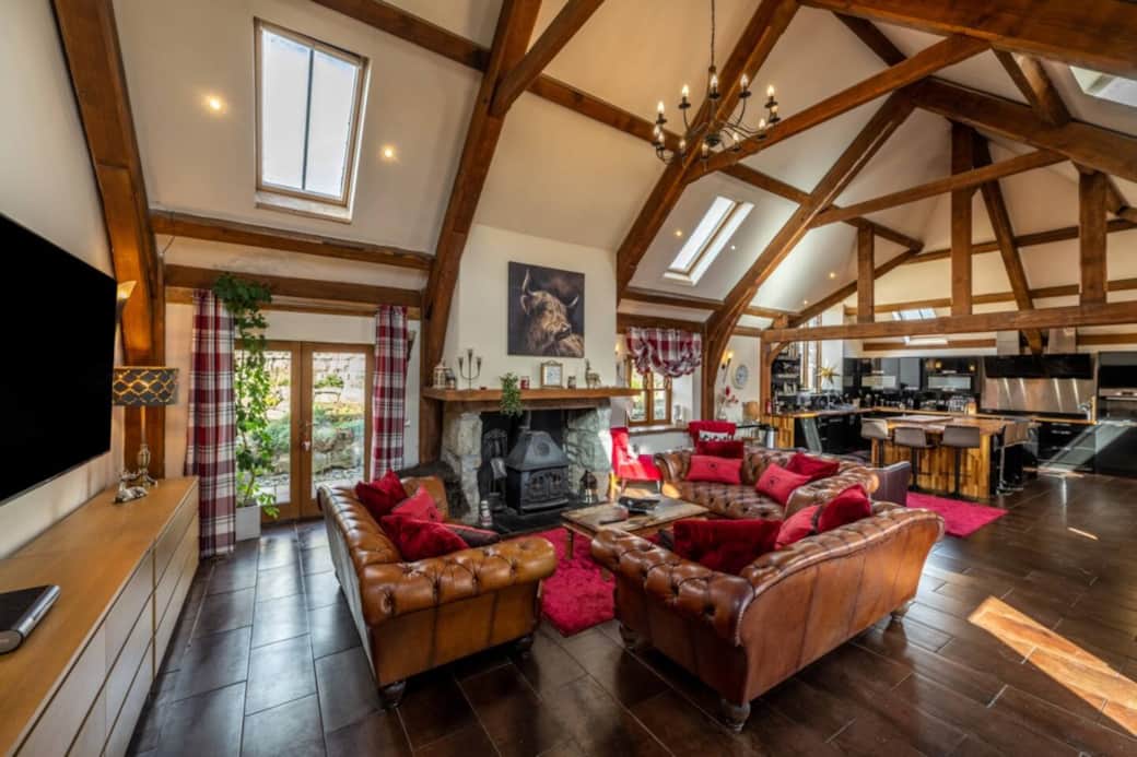 open plan lounge with douglas fir trusses, kitchen and large island