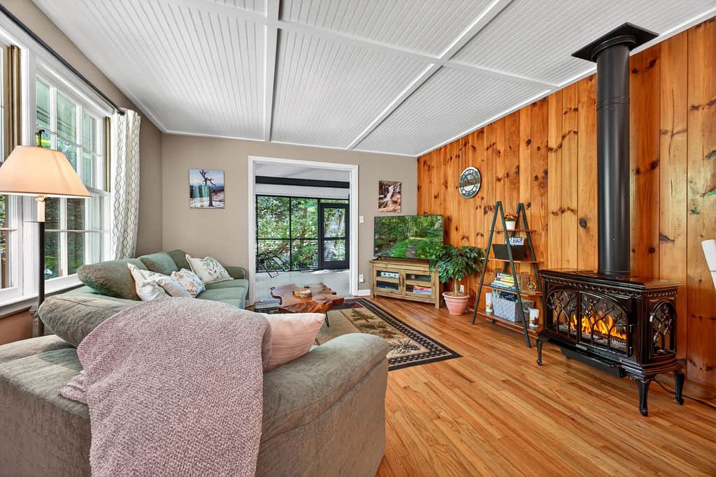 Living room with the screened in porch doors open wide.  You can hear the gentle sound of the creek.