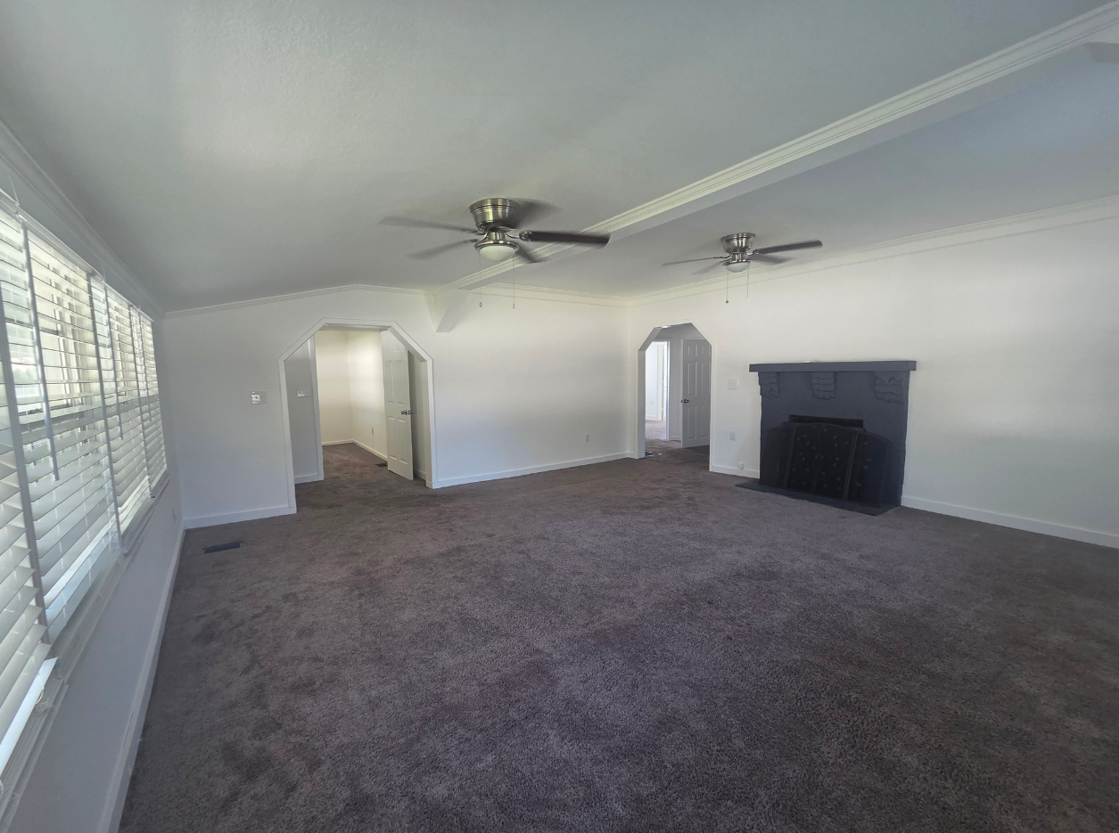 Spacious Living Room with Fireplace, Ceiling Fan & Natural Light. Lakeland, FL