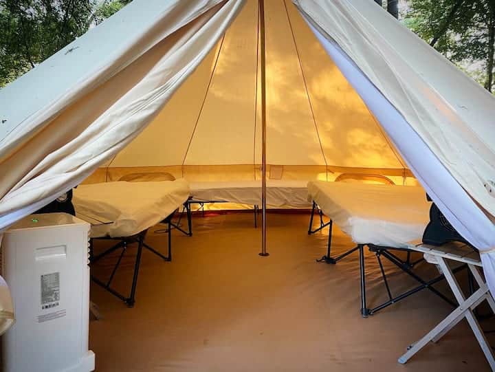 2 Queen sized beds, 1 twin bed, side table, fans, electricity, and AC/Heat.  Guest provides bedding.