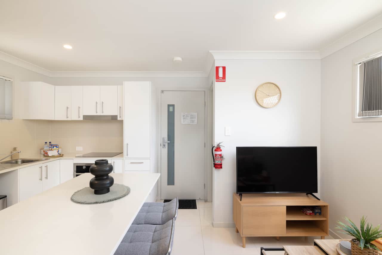 Living Area: Bright living space with comfortable seating and TV 