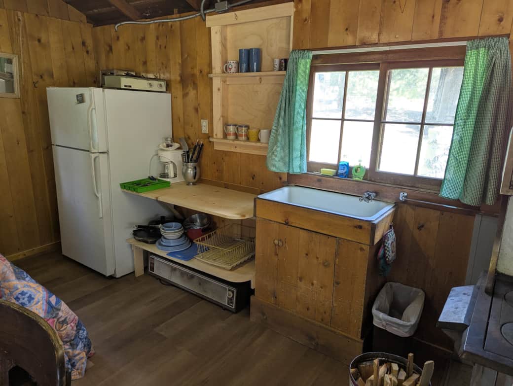 Cabin 3 is a cozy rustic cabin that features a wood-burning stove.
