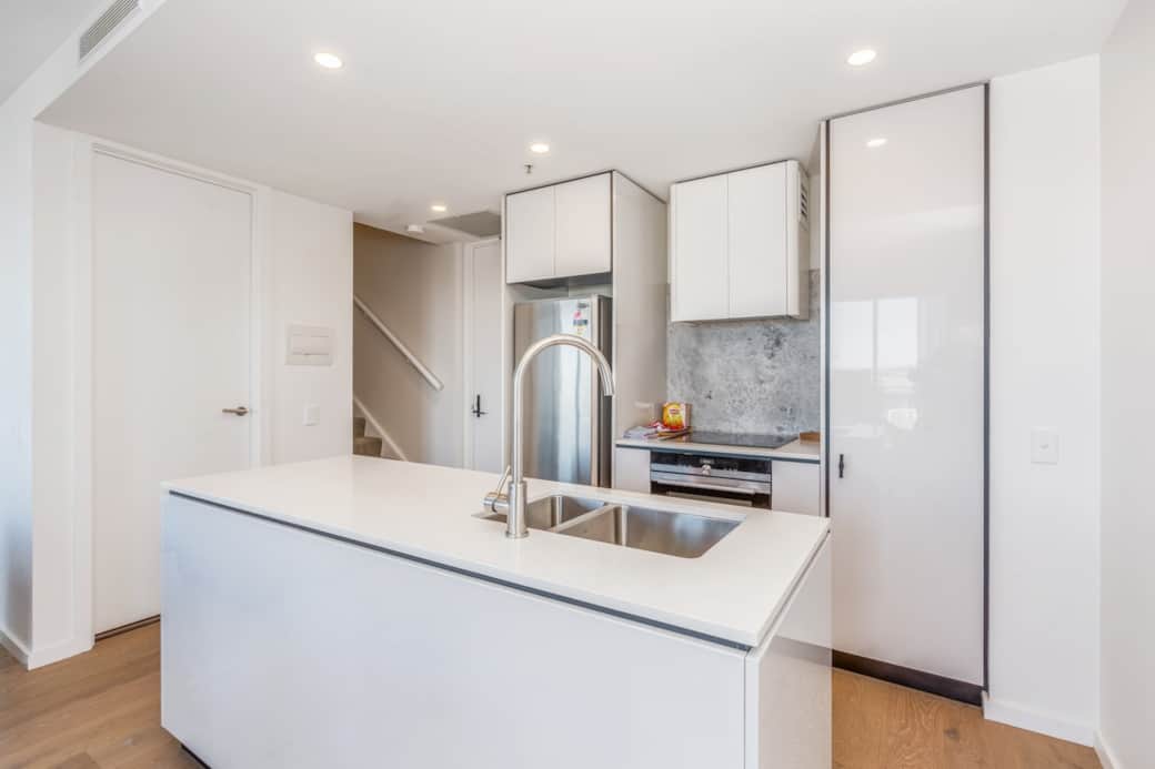 Prepare meals in style in our modern kitchen, the sleek white cabinetry and stainless steel appliances create a clean, contemporary look. Whether you're cooking for yourself or hosting a dinner party, this kitchen has everything you need.