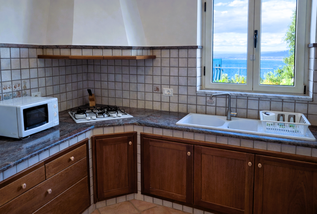 Generously equipped kitchen with a large, modern refrigerator and dishwasher