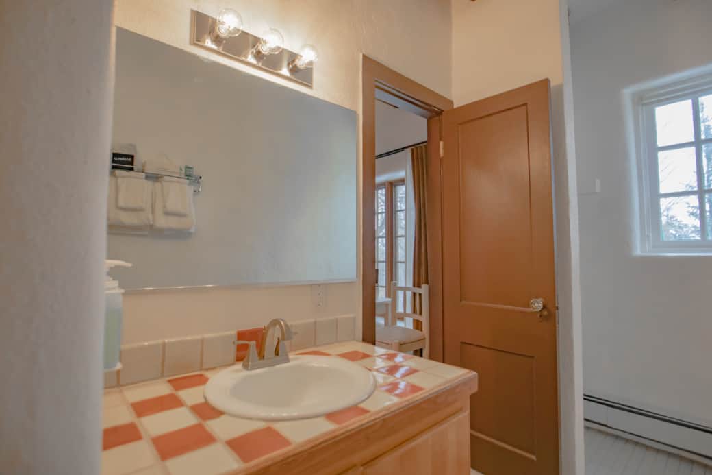 Closet in bathroom for hanging clothes.