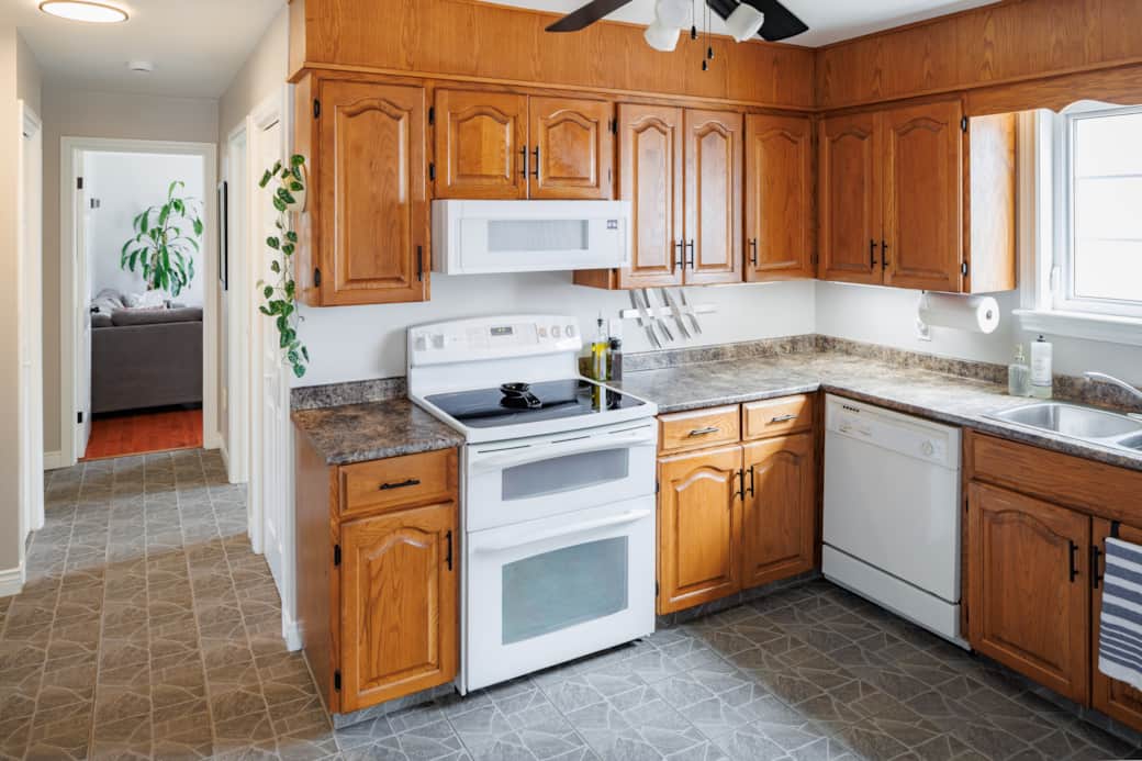 Bright, fully equipped kitchen with ample counter space and natural light.