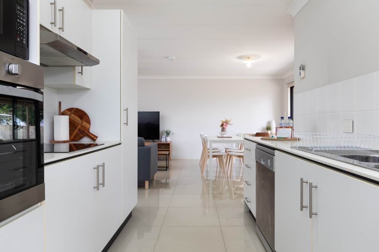 Kitchen: Sleek kitchen with ample storage, modern appliances