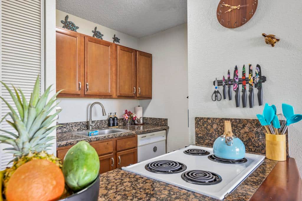 Kitchen with all the comforts of home including full size fridge, stove/oven combo,  and microwave.