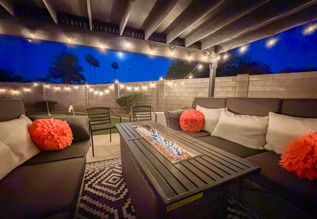 Unwind under twinkling lights around the cozy fire table, the perfect spot for evening conversations, cocktails, and relaxing between soaks in the nearby hot tub.