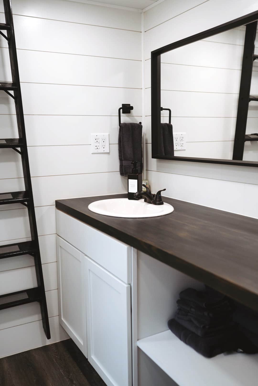 Bathroom Has Shower and Toilet, Stocked With Towels, TP, And More. Ladder Leading Up To Lofted Beds
