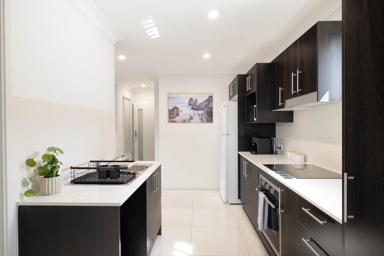 Kitchen: Sleek kitchen with ample storage, modern appliances 