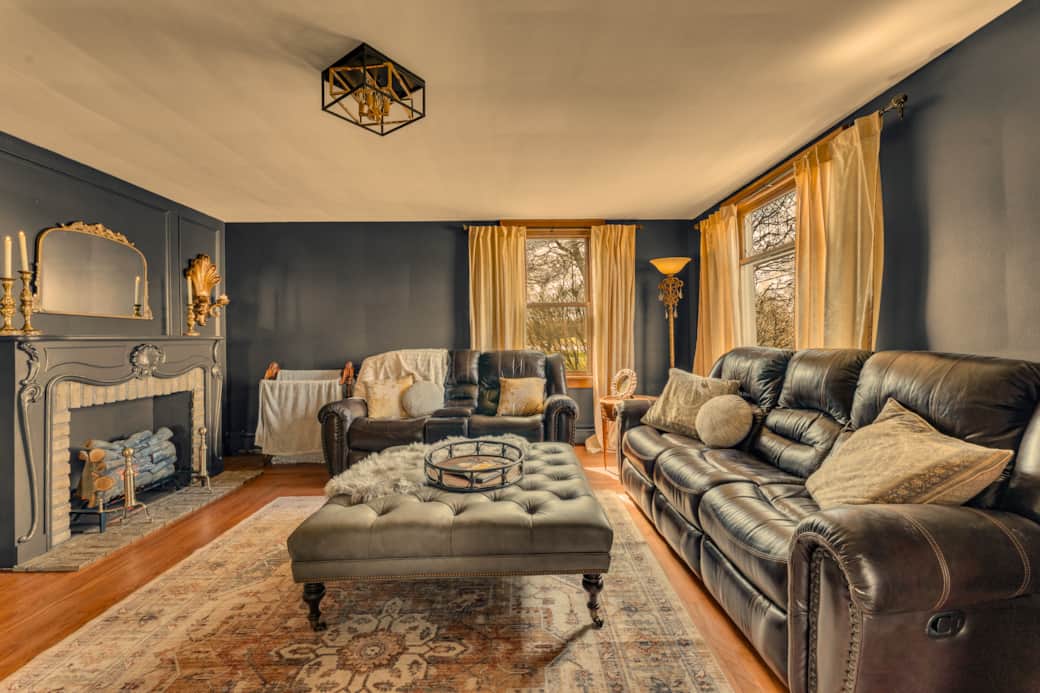 Living room with reclining sofas and an electric fireplace.  Elegant yet cozy!