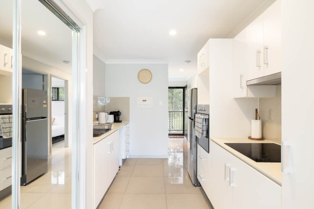Kitchen: Sleek kitchen with ample storage, modern appliances