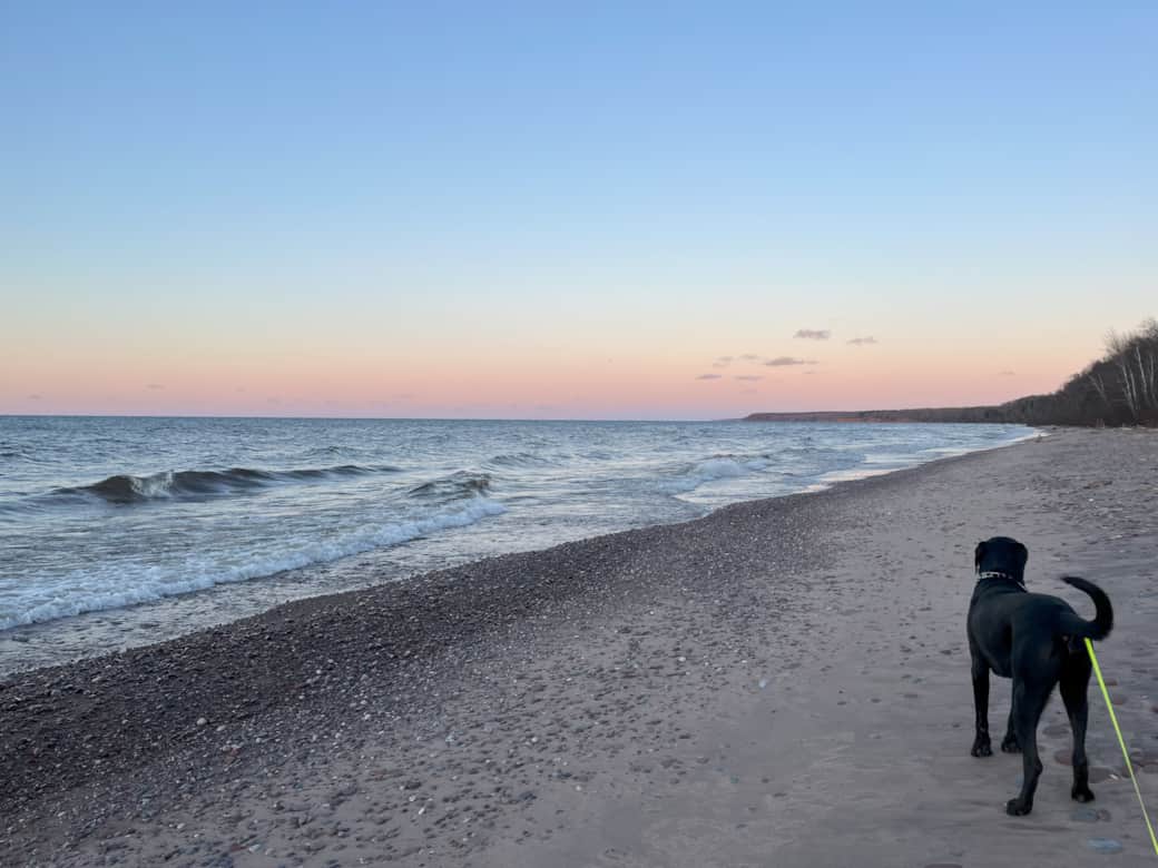 Black river harbor beach with shadow at the sunset