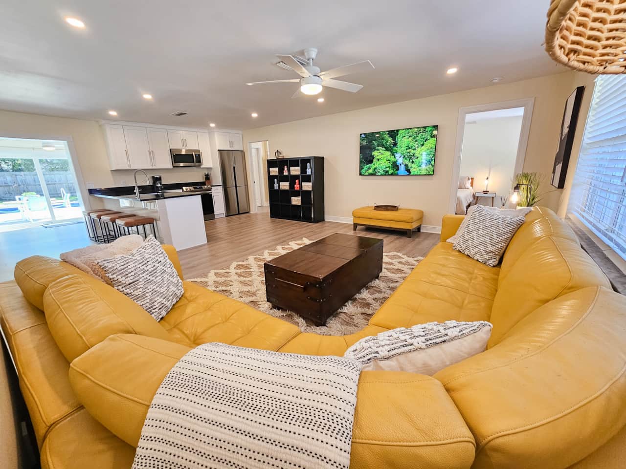 Watch the 65 Inch Smart TV, or the Chef in the Kitchen, from the Couch or the Barstools