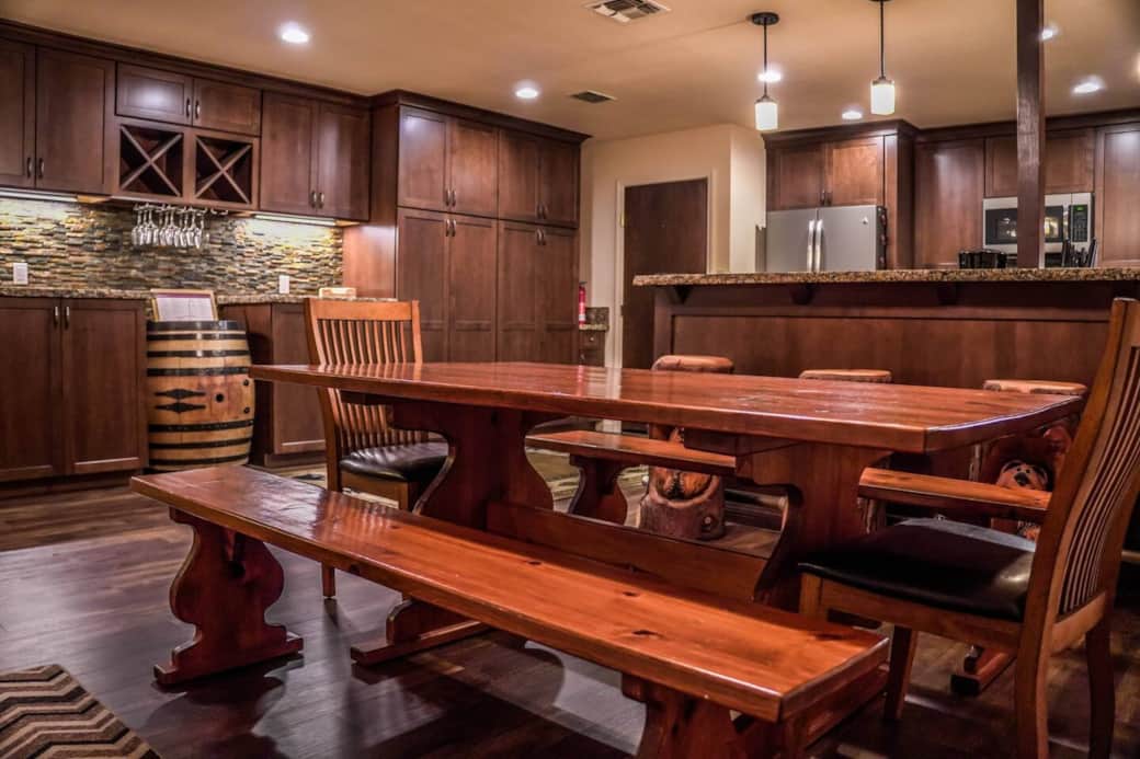 The spacious dining and kitchen area can accommodate everyone. Between the large dining table and bar seating, your whole group can enjoy a meal together.