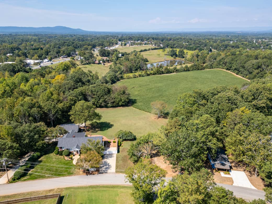 Peaceful 2 Acre Property Aerial View of Main House and Cottage with Open Fields and Mountain Views Peaceful 2 Acre Property Aerial View of Main House and Cottage with Open Fields and Mountain Views
